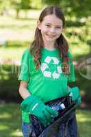 Happy little girl collecting rubbish