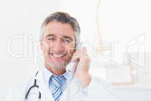 Doctor using landline phone in clinic