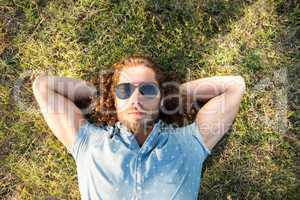 Young man lying down in the park