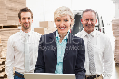 Warehouse team working together on laptop