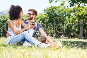 Hipster couple relaxing in the park