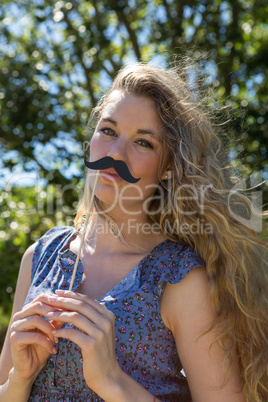 Pretty blonde with fake mustache