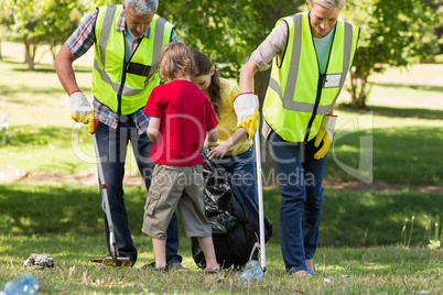 Happy family collecting rubbish