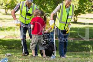 Happy family collecting rubbish