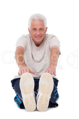 Senior man touching his toes