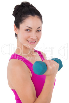 Fit woman lifting blue dumbbell