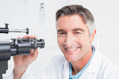 Happy optician using slit lamp in clinic Happy optician using slit lamp in clinic