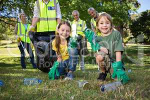 Happy family collecting rubbish