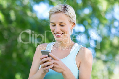 Pretty blonde using smartphone