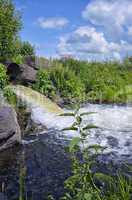 Discharge of water from a metal pipe in the river