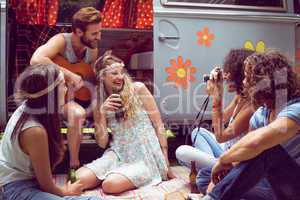 Hipster friends by camper van at festival