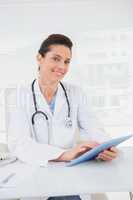 Veterinarian sitting and holding tablet