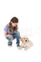 Crouching little girl next dog