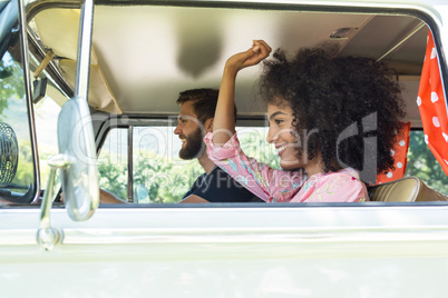 Hipster couple driving in camper van