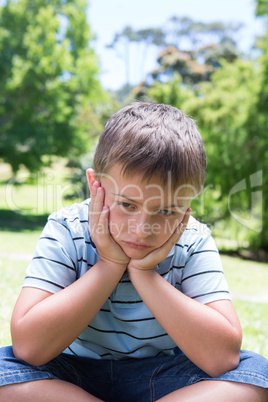 Little boy feeling sad in the park