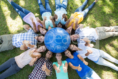 Happy friends in the park lying in circle