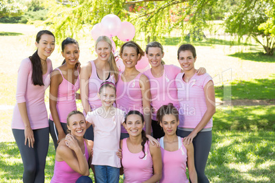 Smiling women in pink for breast cancer awareness