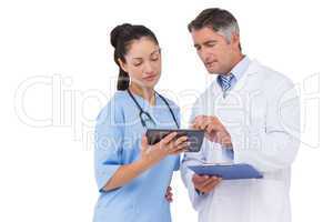 Doctor and nurse looking at clipboard