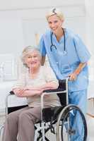 Female nurse pushing senior patient in wheelchair