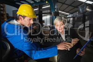 Forklift driver talking with his manager