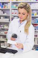 Pharmacist scanning medicines