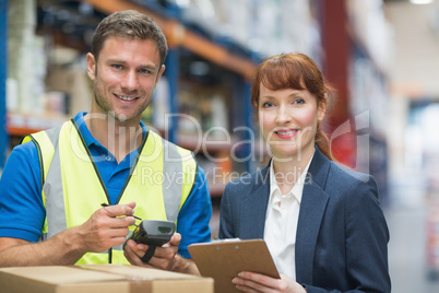 Worker and manager scanning package in warehouse