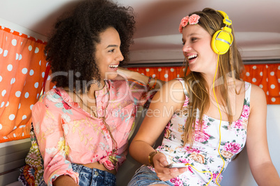 Happy friends on a road trip using listening to music