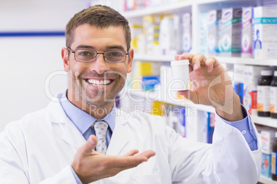 Pharmacist showing medicine jar