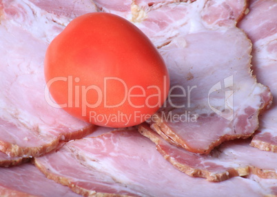 one tomato on ham meat