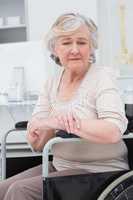 Sad senior patient sitting in wheelchair