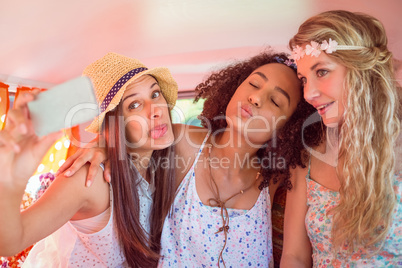 Hipster friends on road trip taking selfie