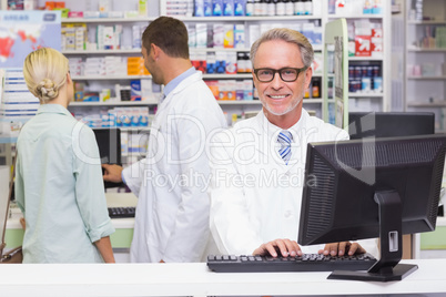 Happy pharmacist looking at camera