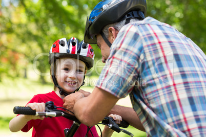 Father attaching his sons cycling helmet