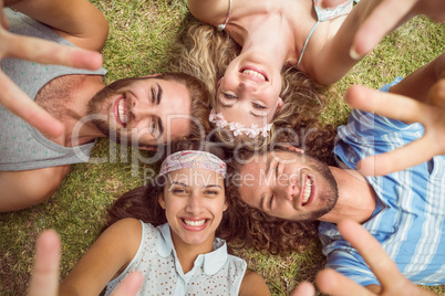 Hipsters lying on grass smiling