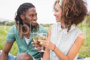 Young couple on a picnic drinking wine