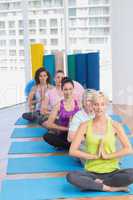 Women meditating in fitness class