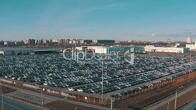 Flying Above Storage Parking Lot of New Unsold Cars, aerial view