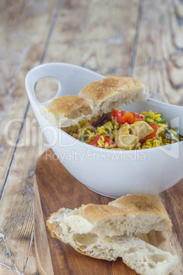 Bowl with curry flavored rice chicken and vegetables