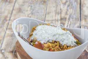 Bowl with curry flavored rice chicken and vegetables