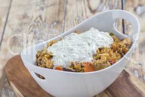 Bowl with curry flavored rice chicken and vegetables