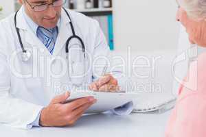 Male doctor writing prescriptions for female patient