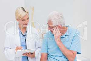 Doctor explaining prescription to senior patient