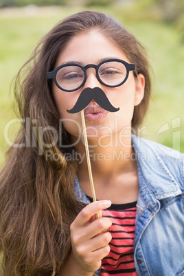 Pretty brunette with fake mustache