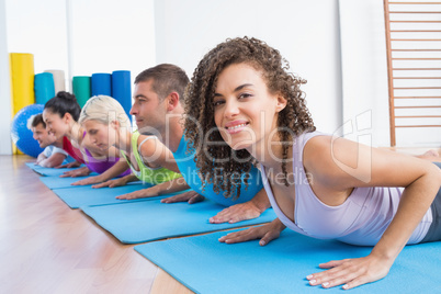 Woman with friends practicing push-ups