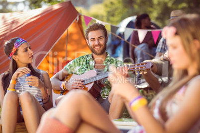 Handsome hipster playing the guitar