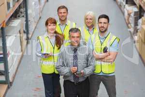 Team standing behind their boss