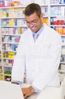 Handsome pharmacist using the computer