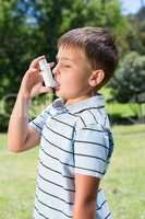 Little boy using his inhaler