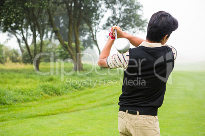 Golfer teeing off