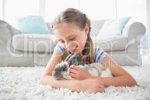 Girl playing with rabbit in living room